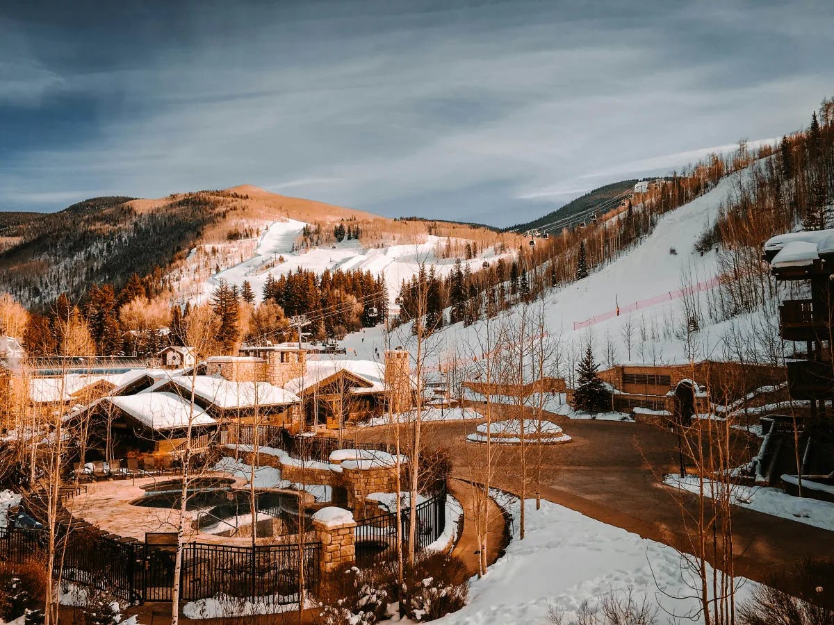 The town of Vail with wooden buildings amidst snowy hills.