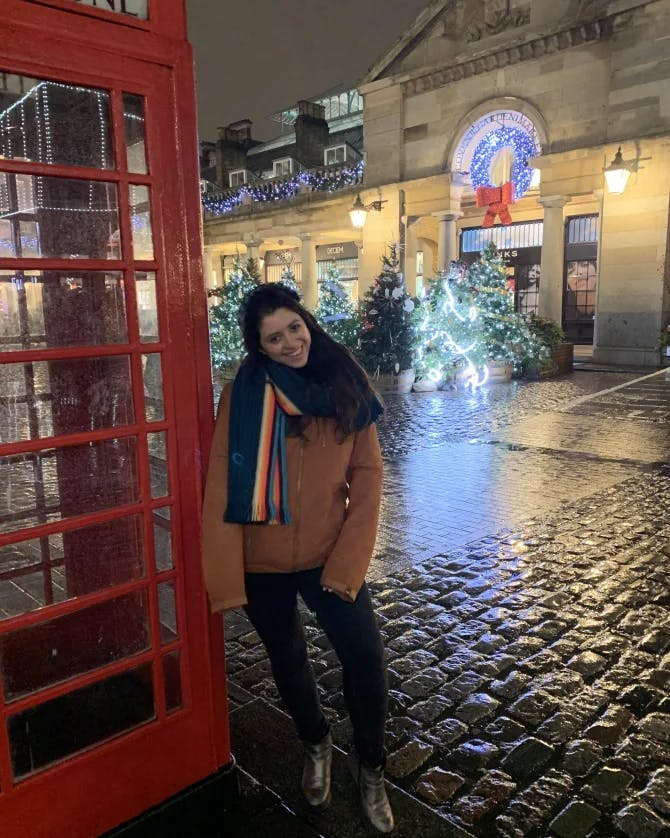 Picture of Alex standing with a telephone booth