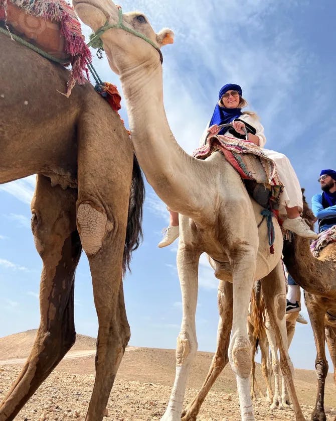 Travel advisor posing with camels