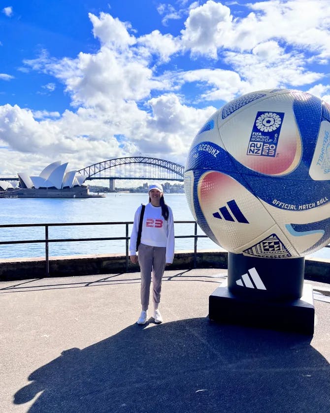 Travel advisor Paige with giant ball overlooking water, bridge and Sydney Opera House
