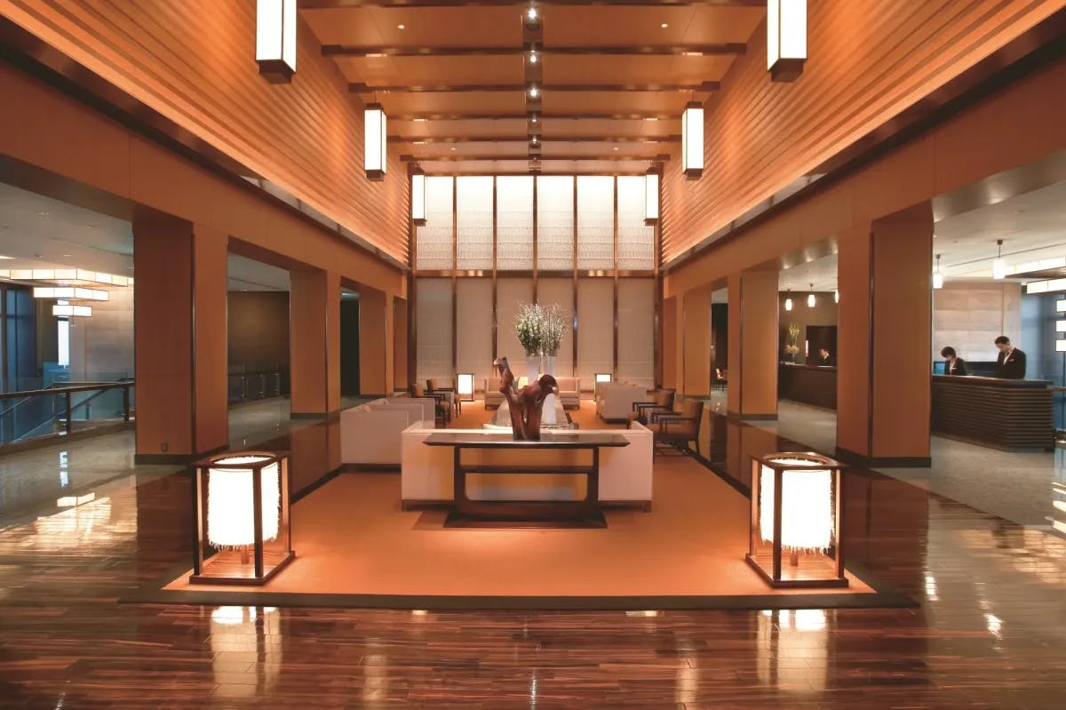 a large lobby area with lantern lights and polished wooden floors