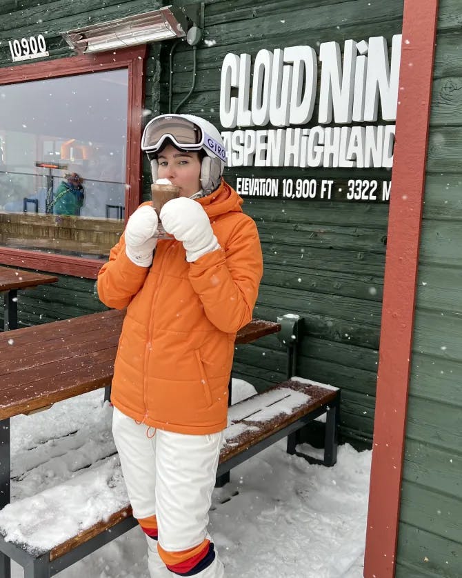 Picture of Emma in orange coat in snow