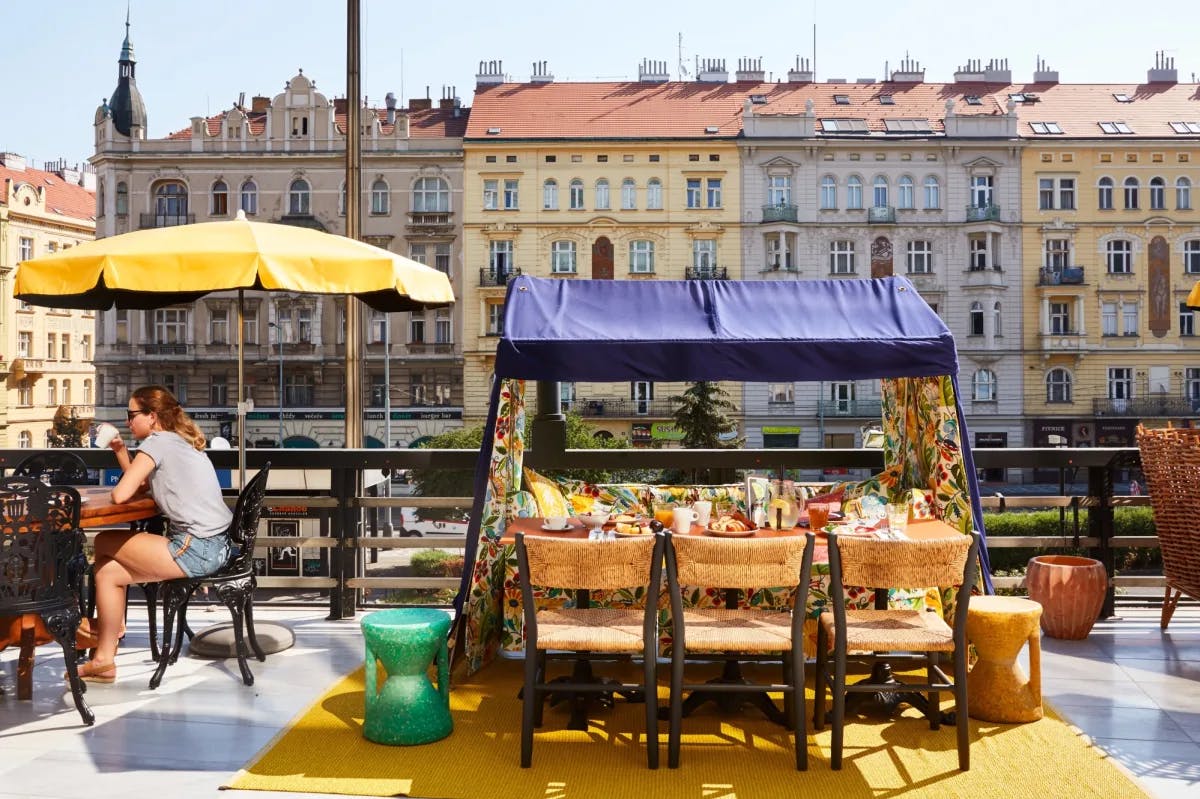 a tented fruit cart on a sunny outdoor urban terrace