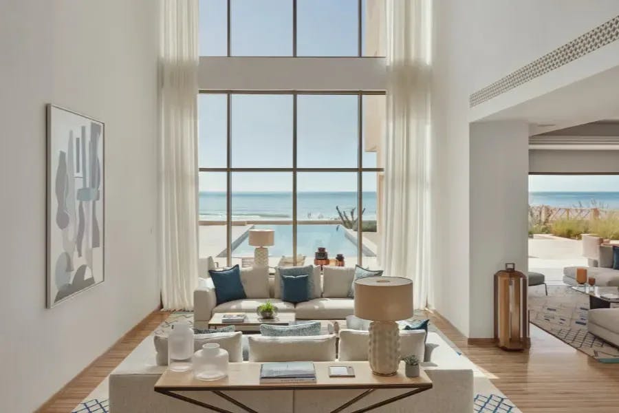 Semi-open-air room at Fairmont Taghazout Bay with the calm waters of the Atlantic visible through bay doors and windows
