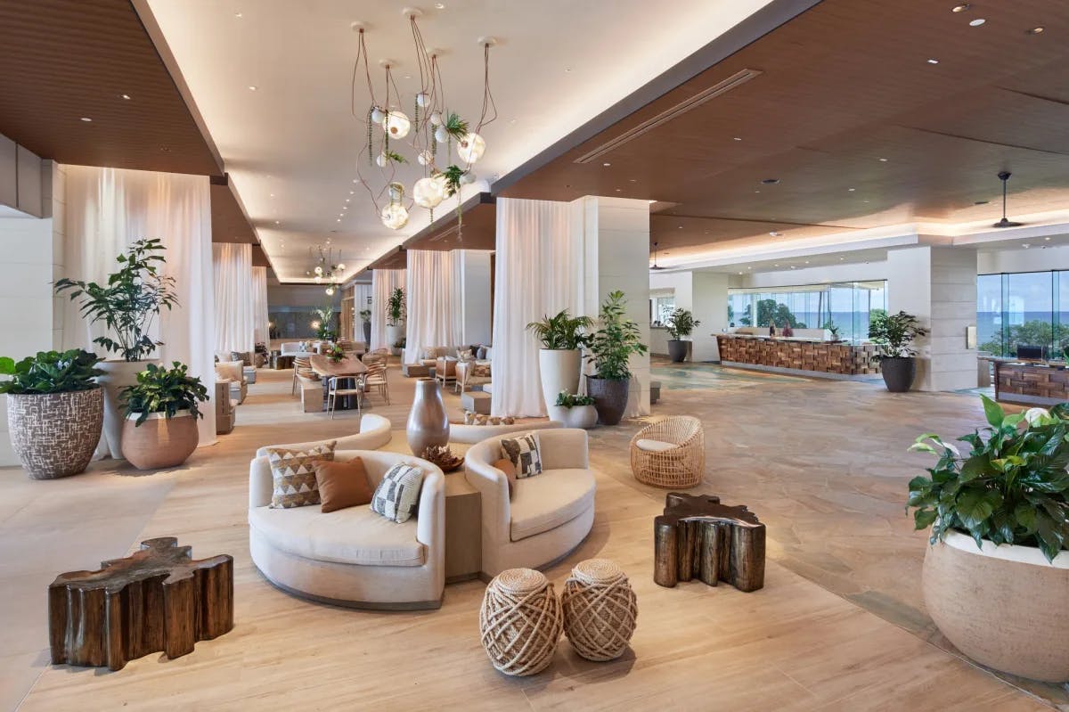 a chic open-air lobby with couches and wooden tables