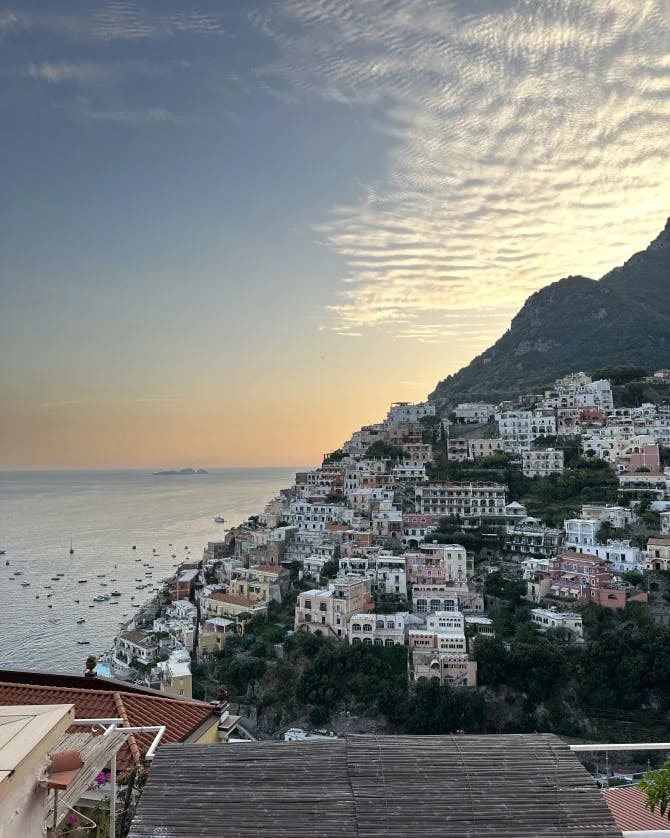 Amalfi Coast at sunset with cliffside buildings