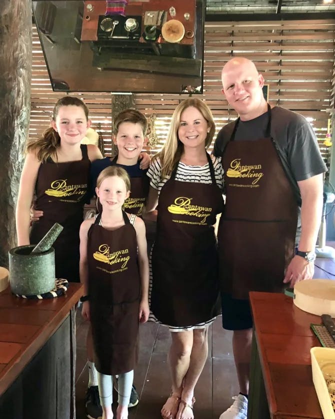 Ashley posing with her family at a cooking class.
