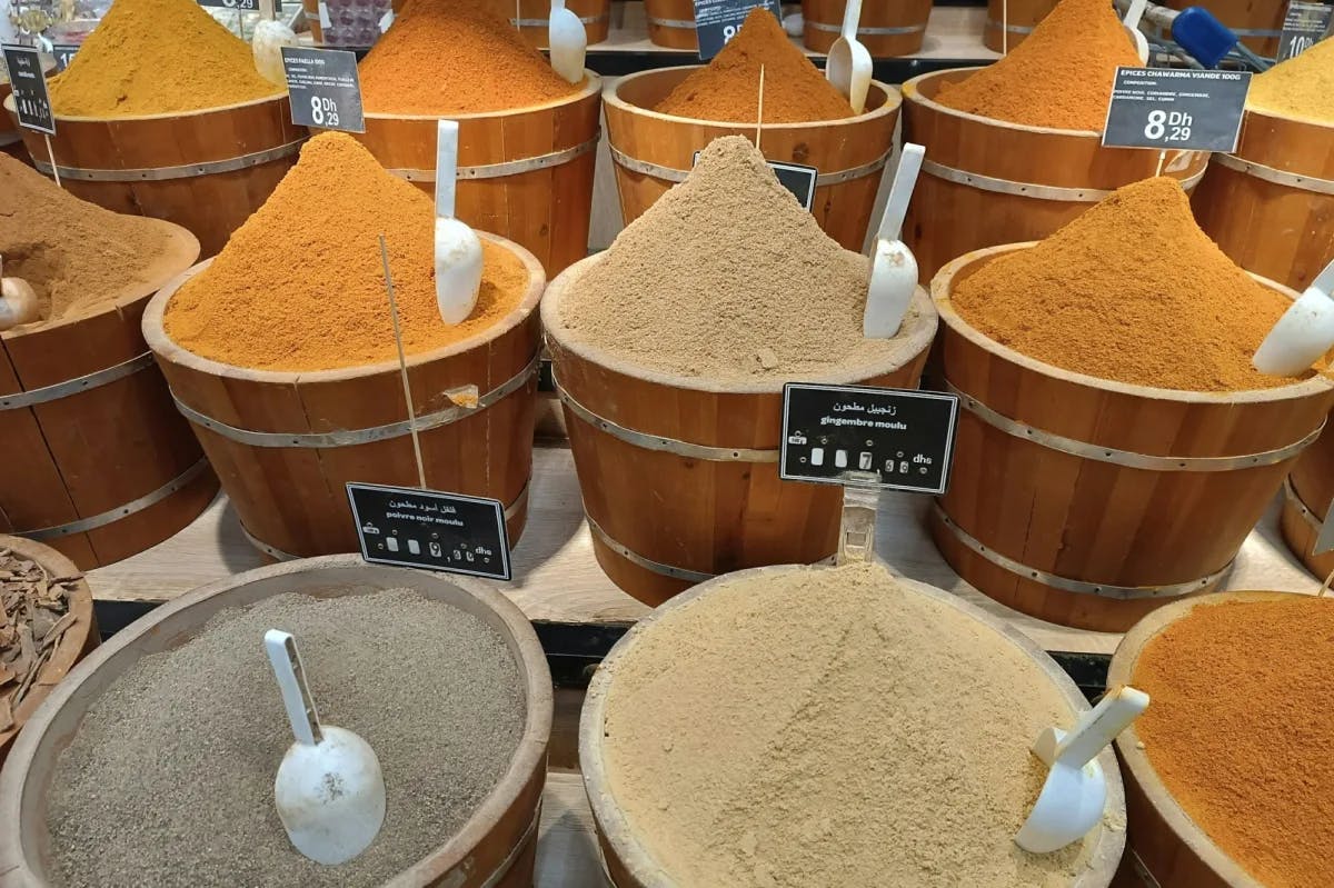a variety of spices fill buckets in a Moroccan spice shop