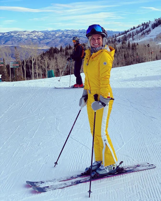 Travel advisor Kristin Rotter skiing in yellow ski suit in Deer Valley