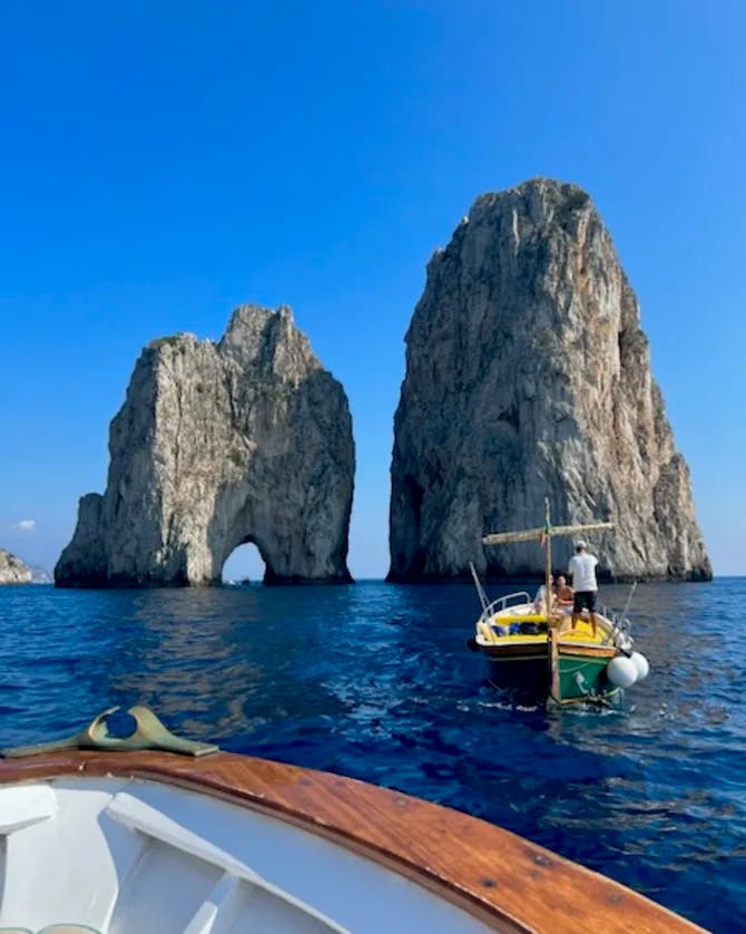 View from the boat of ocean and two large rock structures