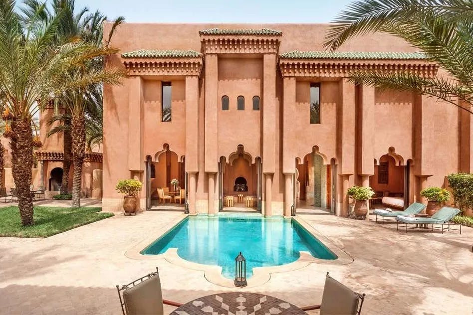 Dusky pink stucco walls with a blend of Moroccan influences and Aman's design-forward philosophy