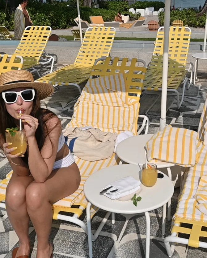 Picture of Emma drinking juice on sunloungers
