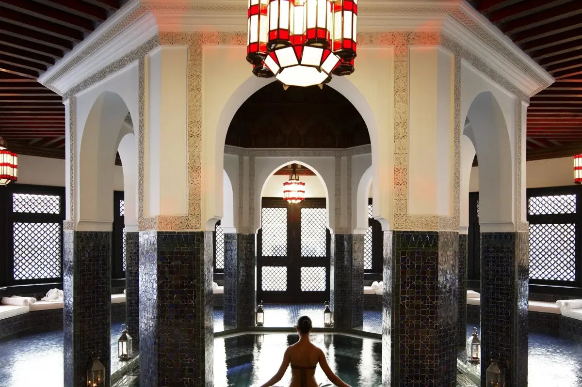 A woman enters a lavish spa in the middle of a Moroccan hammam at La Mamounia