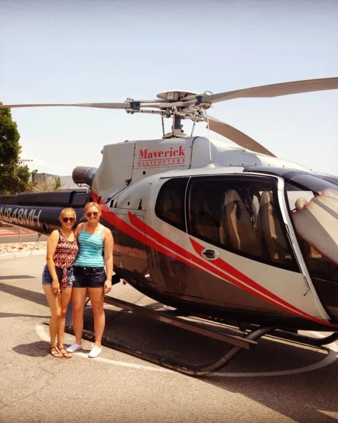 Posing for a picture in front of a helicopter