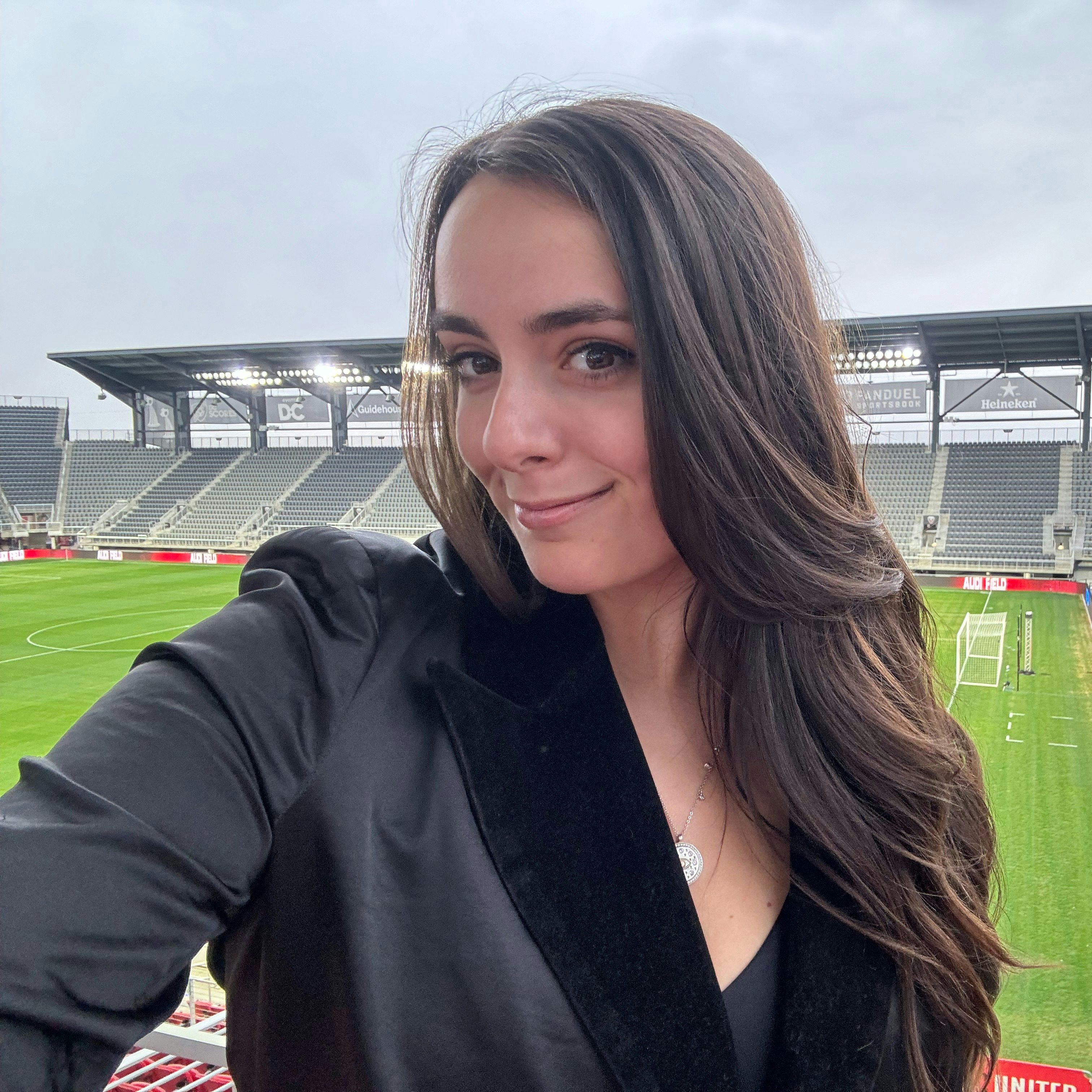 Travel advisor Giovanna Saulle posing for a photo on a sports field