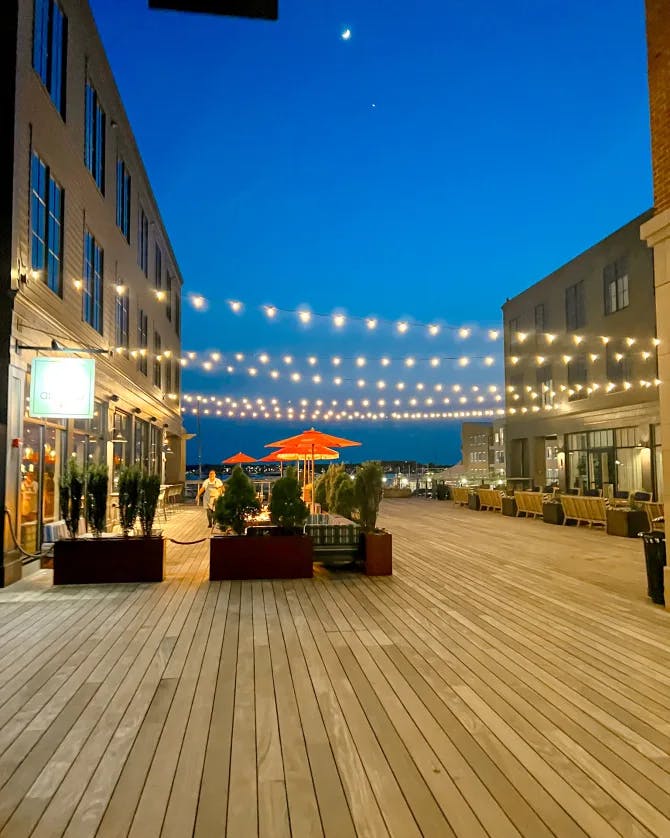 Beautiful outdoor deck area of Hammetts Hotel at night with string lights hanging