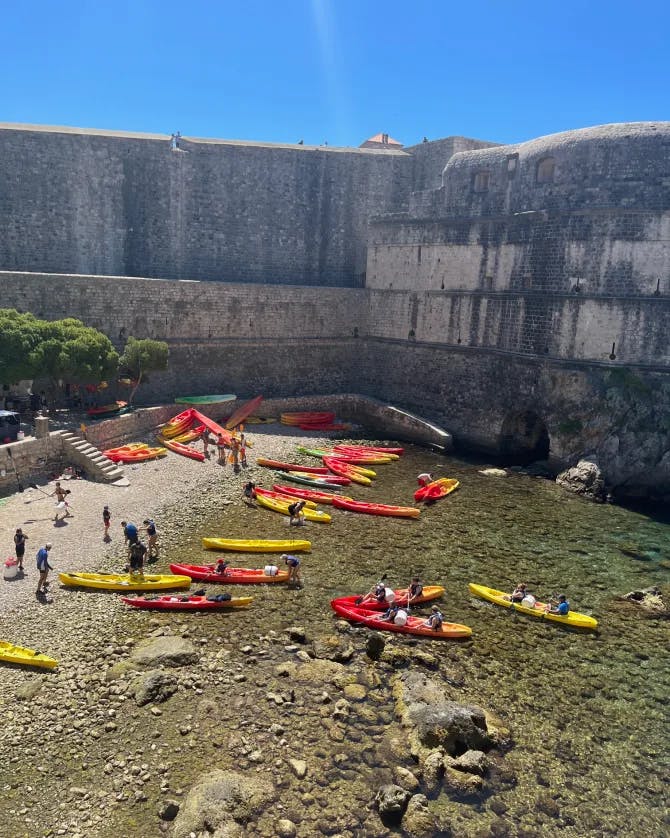 View of people in red and yellow canoes