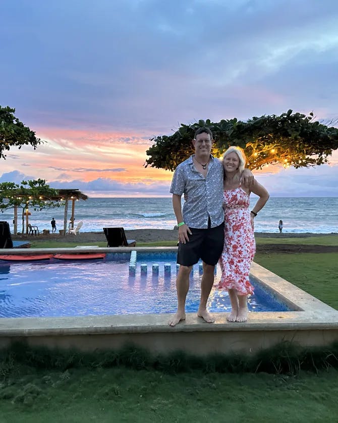 Picture of Jenny with spouse standing along the pool