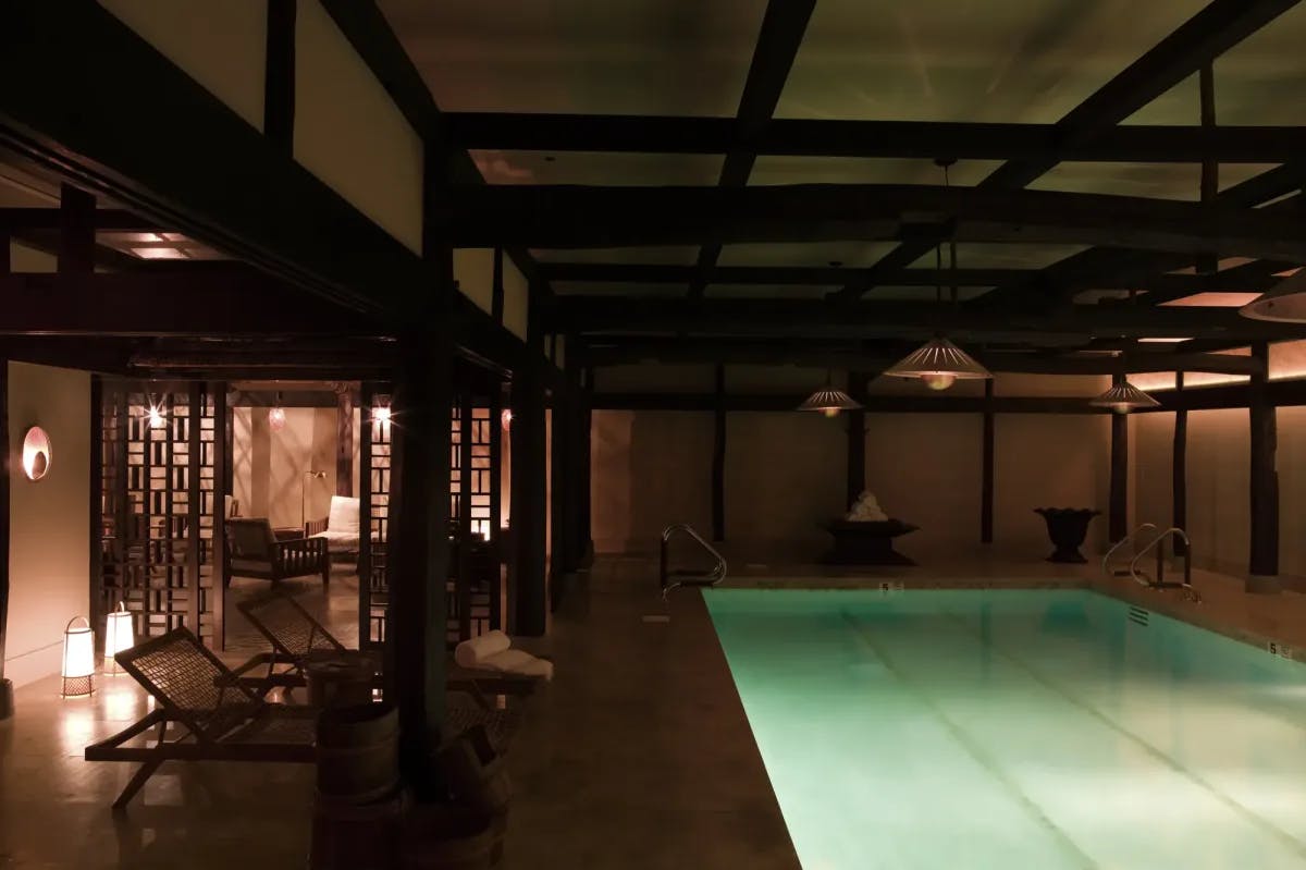 an illuminated pool in a dimly lit room