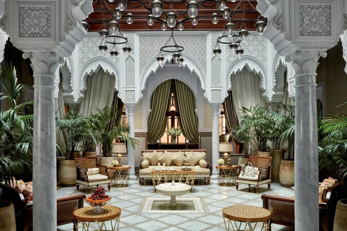 Ornate Moroccan furniture, decor and plants fill an elegantly styled Riad space at Royal Mansour Marrakech
