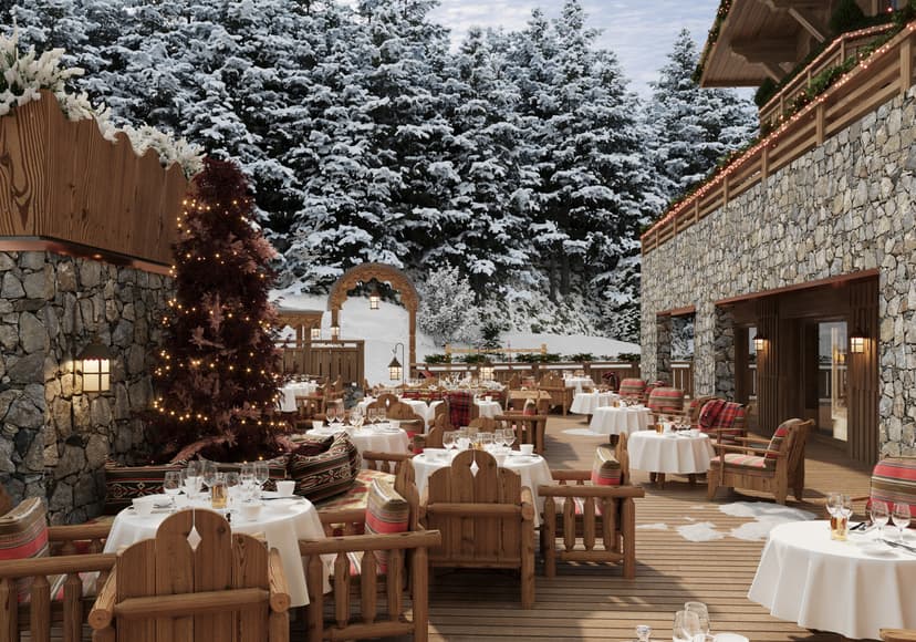 an outdoor terrace with wooden seating in the snowy Alps