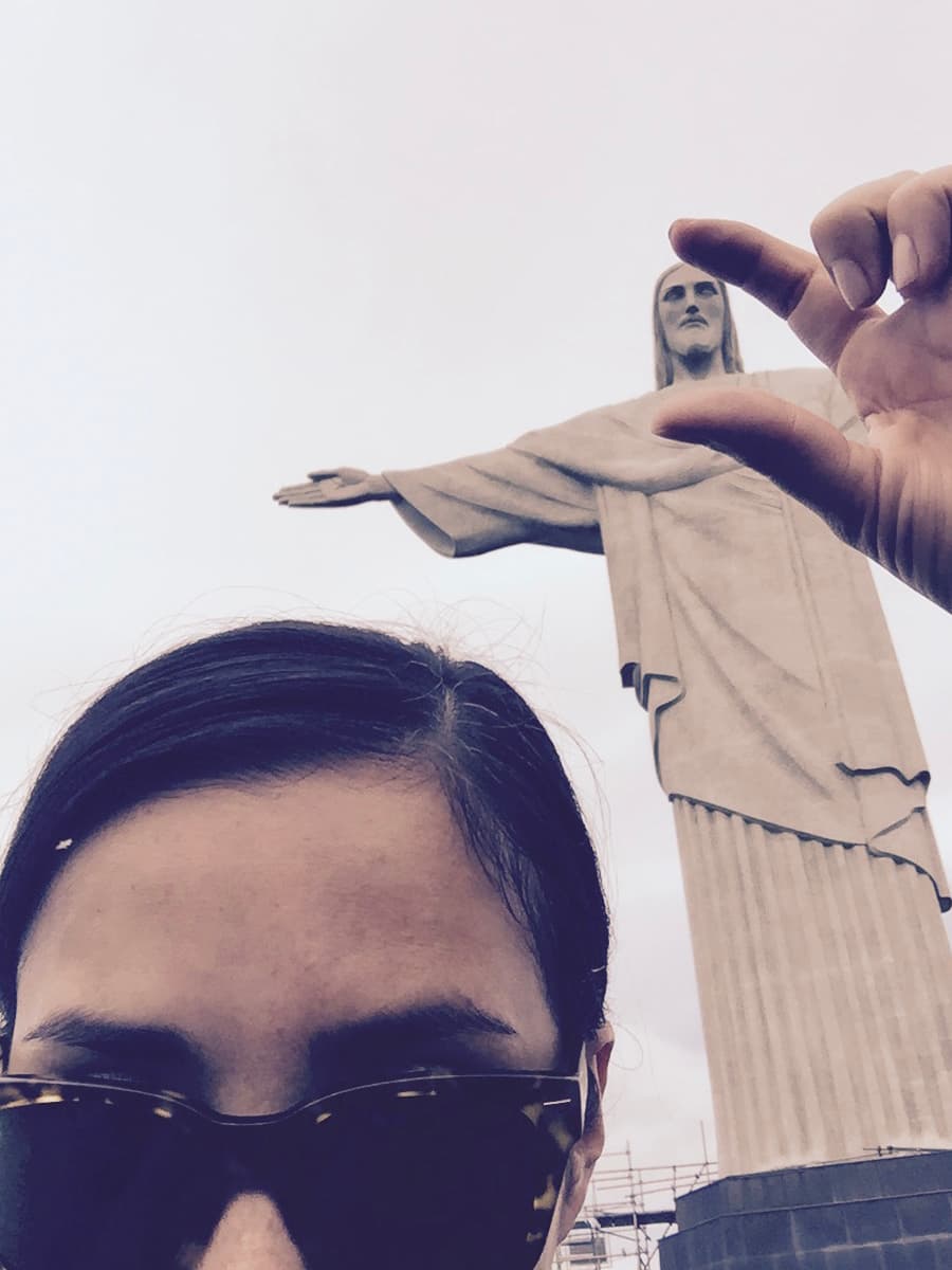 A selfie of Lynette next to the Christ the Redeemer sculpture