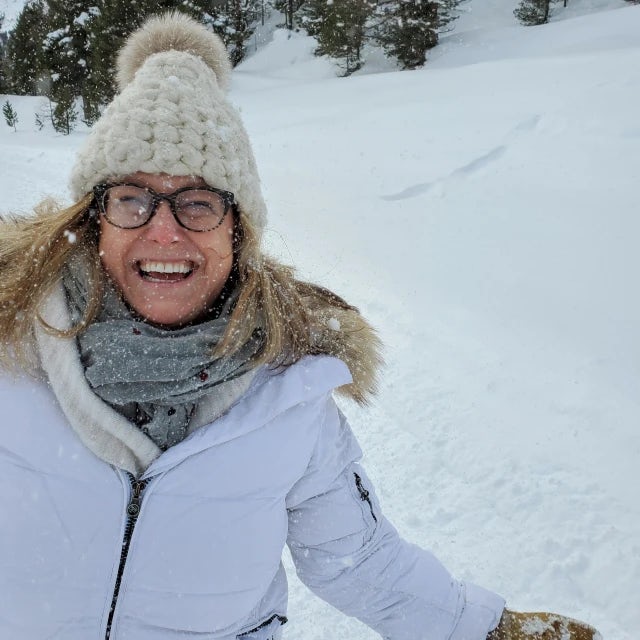 Travel advisor Victoria smiling in snow