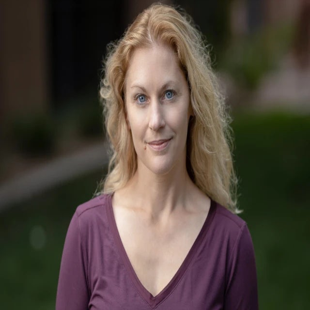 Travel advisor Jane Henzerling with long blonde hair wearing a blue denim button-up 