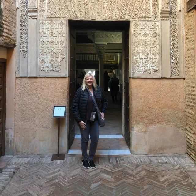 Travel advisor Leah Bedgood posing in front of a doorway in museum